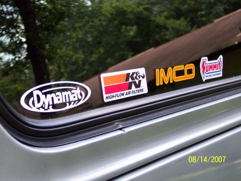1996 Ford Bronco - Vehicle window displays multiple aftermarket performance and racing stickers, including K&N and Summit Racing Equipment.