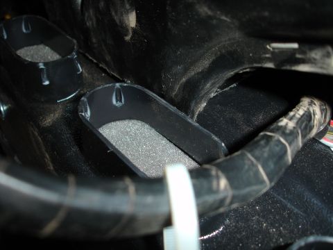 1977 Ford F-150 - Close-up view of interior air vents and ducting, showing foam inserts and a black hose.