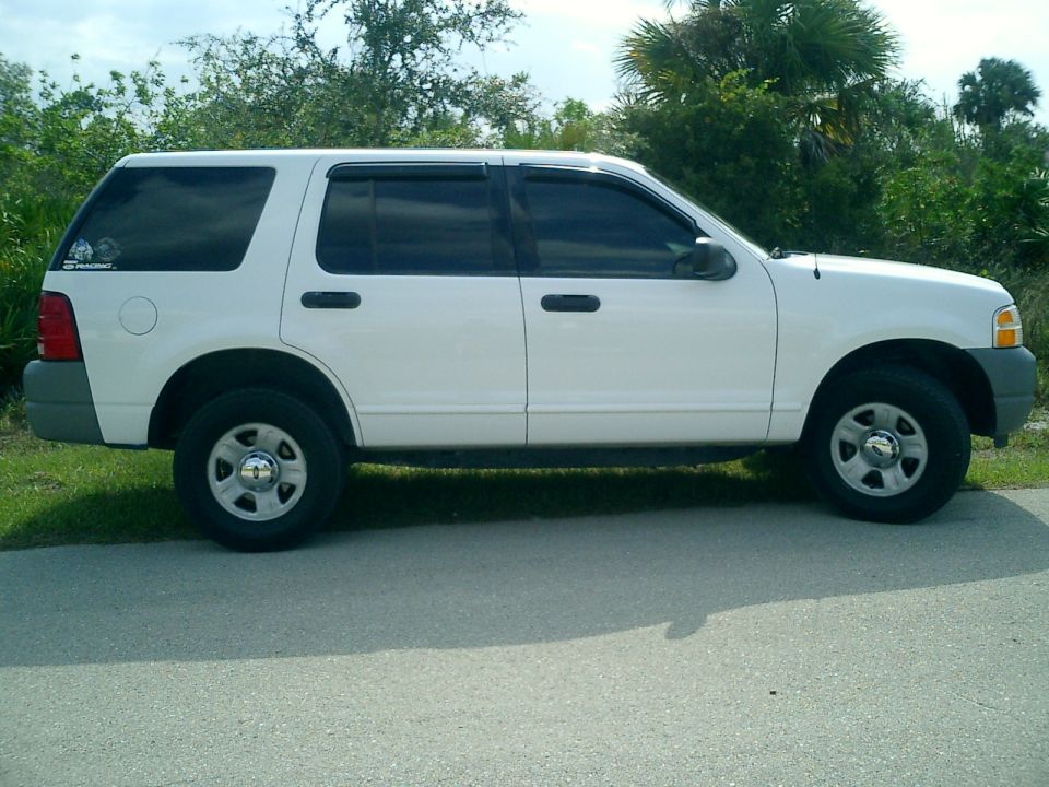 White 2002 Ford Explorer parked on the side of a road