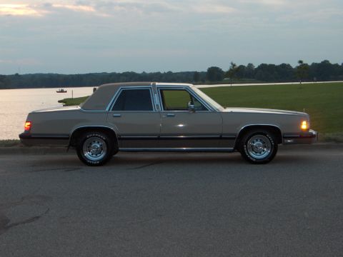 1988 Mercury Grand Marquis - A 1988 Mercury Grand Marquis is seen parked near a body of water at dusk.