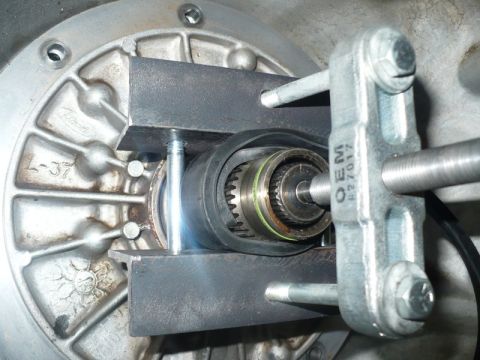 1995 Ford Bronco - A close-up view of a transmission component being worked on with a specialized tool.