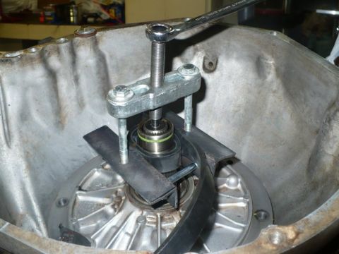 1995 Ford Bronco - A specialized tool is used to remove a bearing from a transmission component.