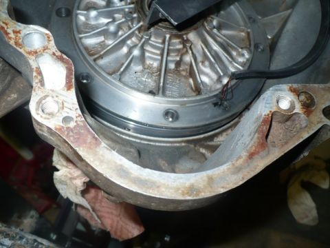 1995 Ford Bronco - A close-up view of a vehicle's transmission or engine component, showing a rusty bracket and wiring.