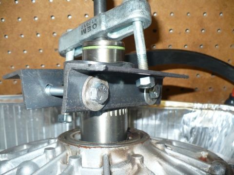 1995 Ford Bronco - A bearing puller tool is used on a component of a vehicle's transmission.