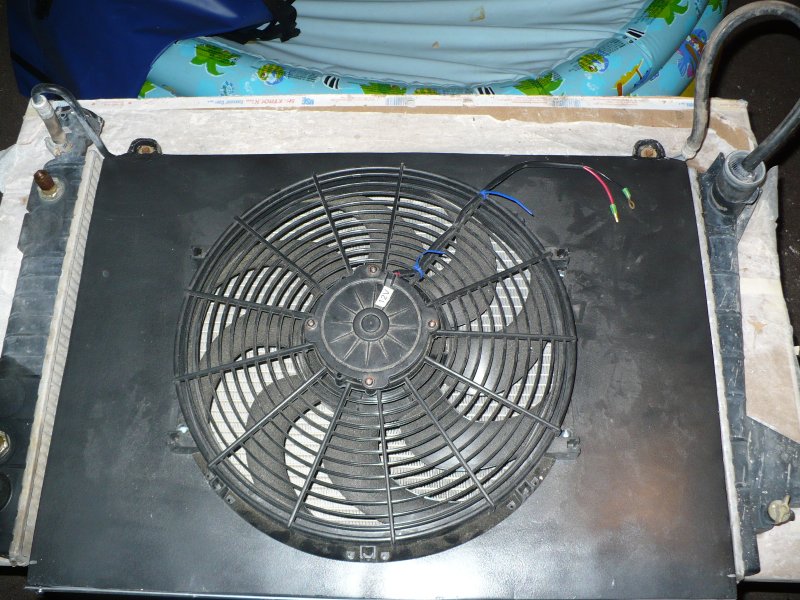 radiator with electric fan attached, wires visible