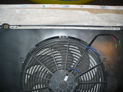 1995 Ford Bronco - Close-up view of an electric cooling fan attached to a vehicle radiator.