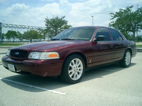 2004 Ford Crown Victoria - Maroon 2004 Ford Crown Victoria with white alloy wheels.
