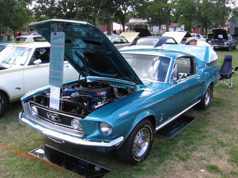 Teal 1967 Ford Mustang coupe, hood open, showing engine