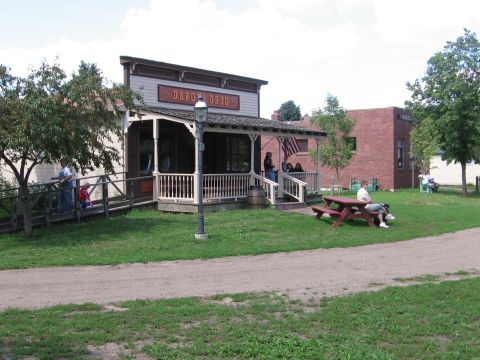 1989 Ford Mustang - A staged old west town scene features a general store and people enjoying the outdoors.