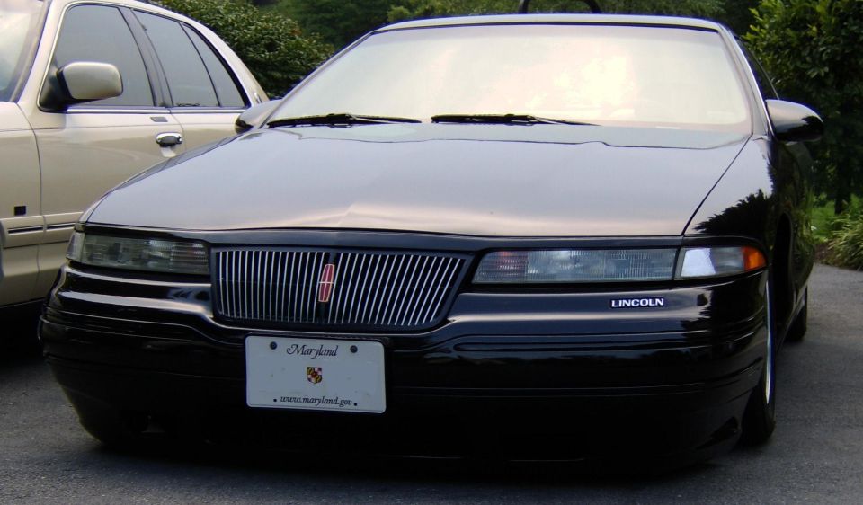 Front of a black Lincoln coupe with chrome grille and Maryland plate