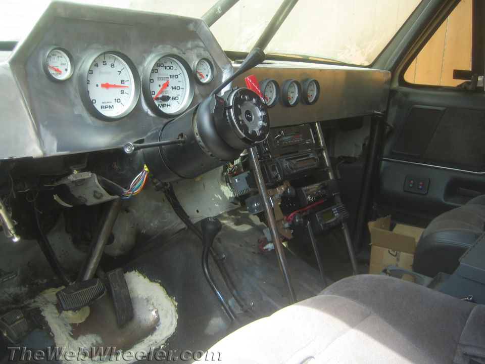 Stripped vehicle interior with aluminum dash, gauges and exposed steering column