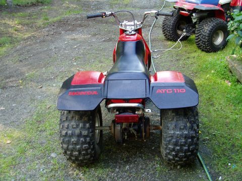 2000 Ford E350 - Honda ATC 110 three-wheeler with another ATV visible in the background.