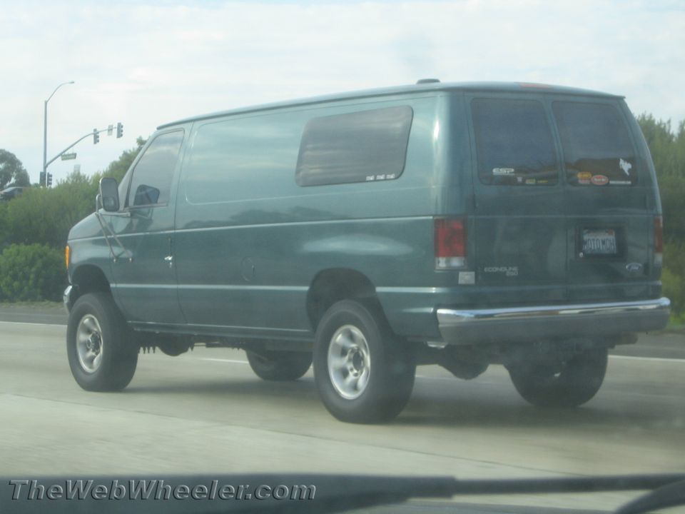 Green 4x4 van, rear view