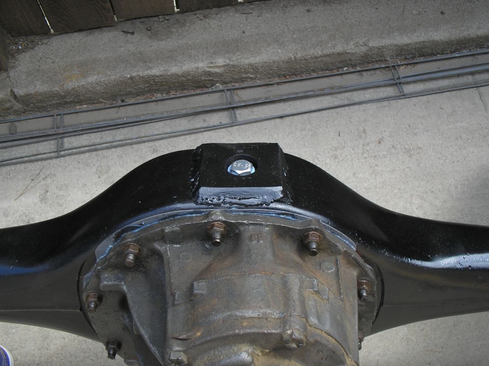 Rear axle differential with black painted housing and a bolted bracket