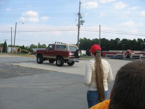 1995 Ford C-350 (Centurion Conversions) - A modified Ford Bronco with a spare tire mounted on the back is parked in a lot.