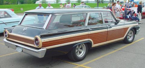 1969 Ford Fairlane - A vintage wood-paneled station wagon is parked at an outdoor event.