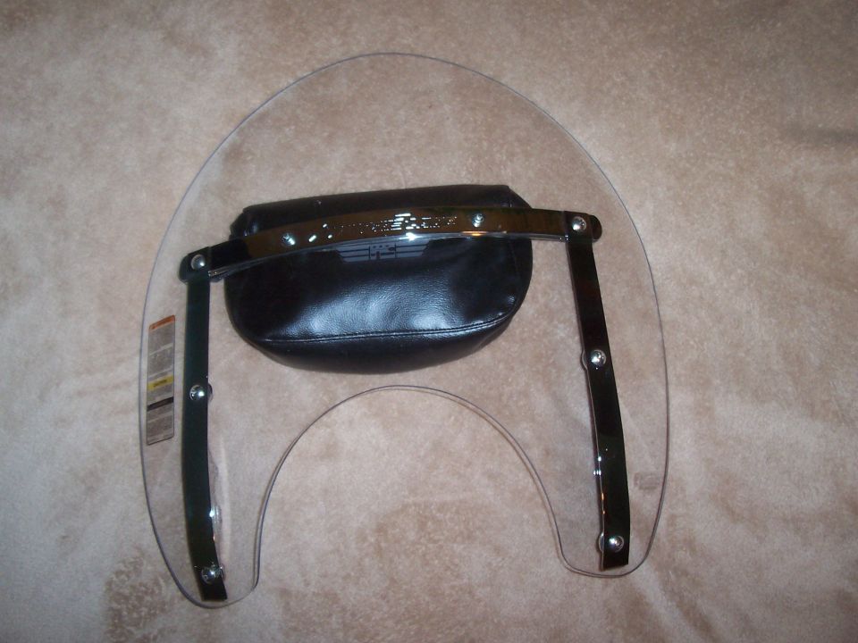 Motorcycle windshield with a black leather bag attached to the chrome support bars