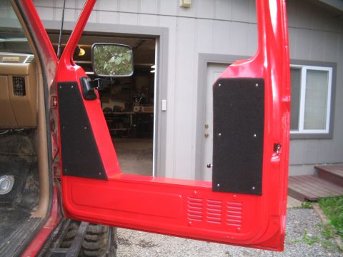1989 Ford Bronco - Interior of a red vehicle door showing custom sound deadening panels.