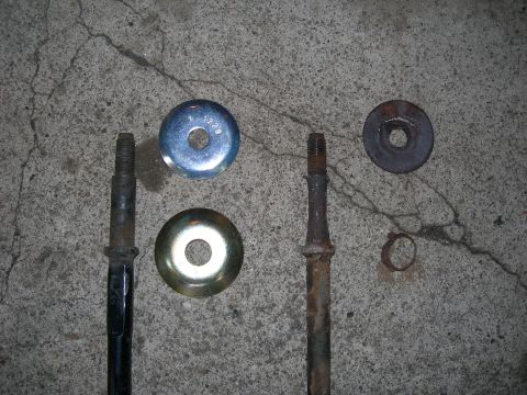 1992 Ford Taurus - Various car parts, including bolts and washers, are laid out on a concrete surface.
