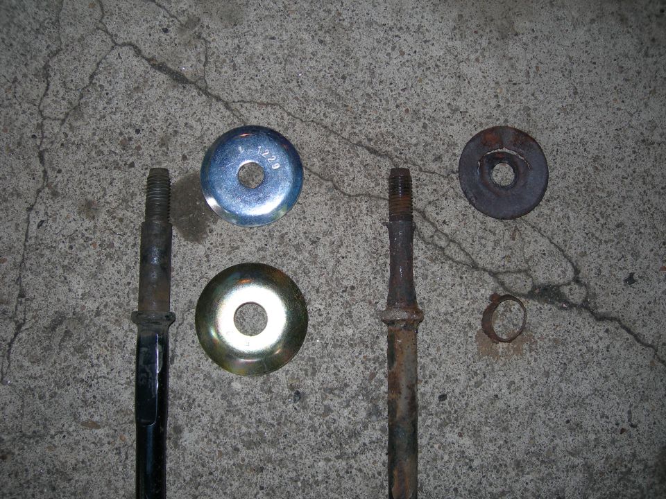 Two bolts with washers and a clip on concrete