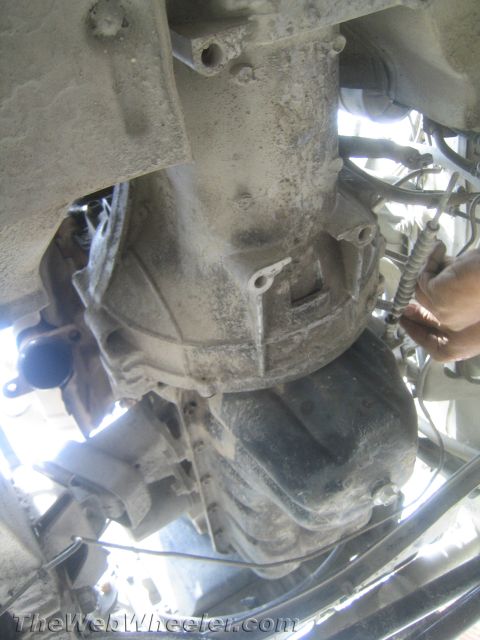 1987 Suzuki Samurai - Close-up view of a vehicle's drivetrain components, focusing on the transmission and oil pan.