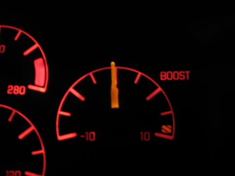 1992 Ford Crown Victoria - The illuminated dashboard displays a boost gauge and speedometer, indicating the vehicle's performance metrics.