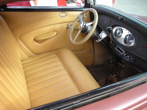 1998 Ford Crown Victoria - Interior view of a vintage automobile with tan upholstery and a classic dashboard.