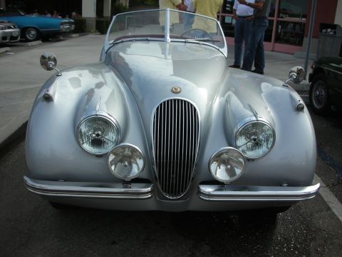 1998 Ford Crown Victoria - A classic silver convertible is parked outdoors, with other vehicles visible in the background.