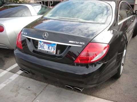 1998 Ford Crown Victoria - Rear view of a black Mercedes-Benz CL63 AMG parked next to a silver vehicle.