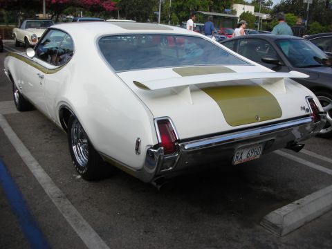 1998 Ford Crown Victoria - Rear view of a classic 1969 Oldsmobile 442 parked in a lot.
