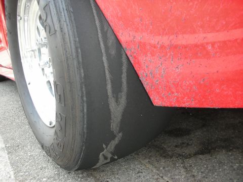 1998 Ford Crown Victoria - This drag racing tire shows significant wear and tear from use on the track.