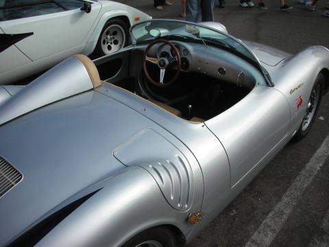 1998 Ford Crown Victoria - A silver convertible sports car is parked next to a white Lamborghini at an outdoor gathering.