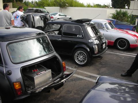 1998 Ford Crown Victoria - A gathering of classic cars including Mini Coopers and a Porsche 356 replica.