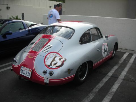 1998 Ford Crown Victoria - A silver Porsche 356 with racing decals is parked next to a blue car.