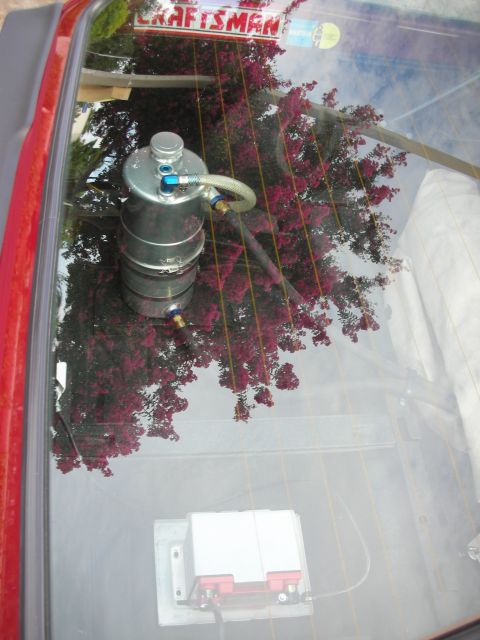 1998 Ford Crown Victoria - A custom oil catch can and battery are visible inside the vehicle, with a 'Craftsman' sticker on the rear window.