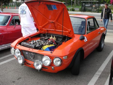 1998 Ford Crown Victoria - Orange Lancia Fulvia coupe with hood open, parked next to a red car.