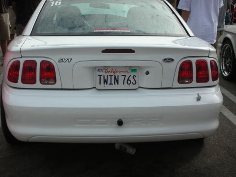 1998 Ford Crown Victoria - Rear view of a white 1996 Ford Mustang SVT Cobra with a California license plate.