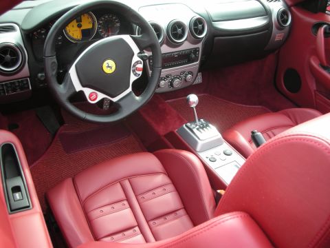 1998 Ford Crown Victoria - Interior view of a Ferrari showing red leather seats and the central console with a gated shifter.