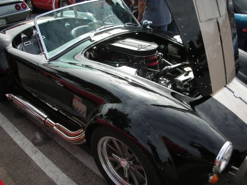1998 Ford Crown Victoria - Black AC Cobra with engine exposed, side exhaust pipes and racing stripes on the hood.