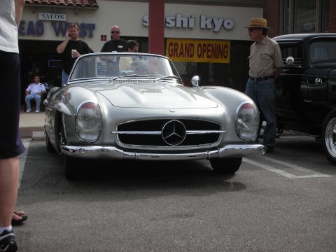 1998 Ford Crown Victoria - Silver Mercedes-Benz 300 SL convertible parked next to a black car.