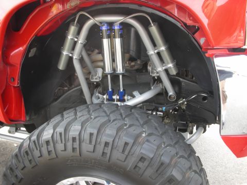 1998 Ford Crown Victoria - Custom suspension setup with dual shocks and aggressive off-road tire.