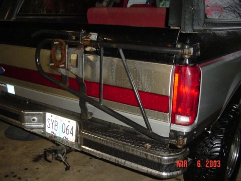 1989 Ford Bronco - The rear of a pickup truck shows a removed tire carrier mount and a license plate. The date MAR 6, 2003 is visible.