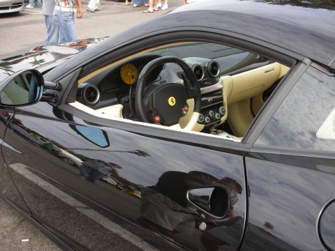 1998 Ford Crown Victoria - Interior view of a black Ferrari with tan seats and a yellow tachometer.
