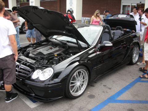 1998 Ford Crown Victoria - A black convertible is displayed with its hood open, revealing the engine compartment.