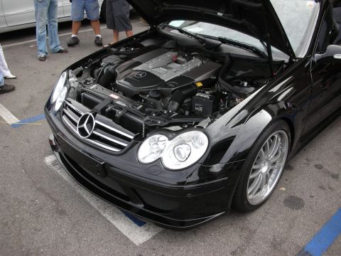 1998 Ford Crown Victoria - A black Mercedes-Benz CLK is shown with its hood open, revealing the engine and front grille.