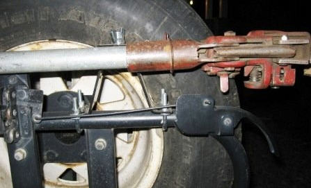1995 Ford Bronco - A Hi-Lift jack is mounted to the frame of a vehicle, near the rear wheel.