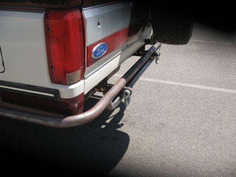 1991 Ford Bronco - The rear of a Ford Bronco shows a custom metal bumper and spare tire carrier attached.
