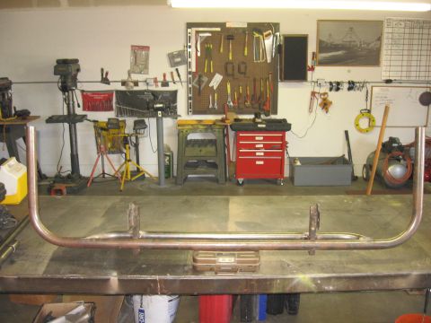 1991 Ford Bronco - A custom rear bumper is being fabricated in a workshop setting, with tools and equipment visible in the background.