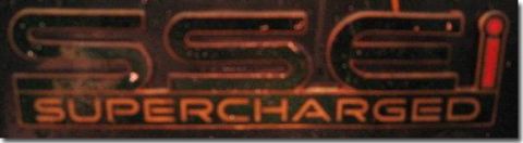 1992 Ford Crown Victoria - This is a close-up of a "SSEi SUPERCHARGED" emblem, indicating a vehicle with a supercharged engine.