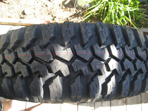 1989 Ford Bronco - A close-up view of the aggressive tread pattern on a Maxxis Bighorn tire, prominent lugs and siping.